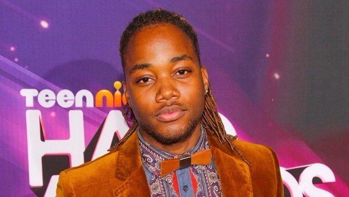 Leon Thomas Disney performing on stage, highlighting his musical talents
